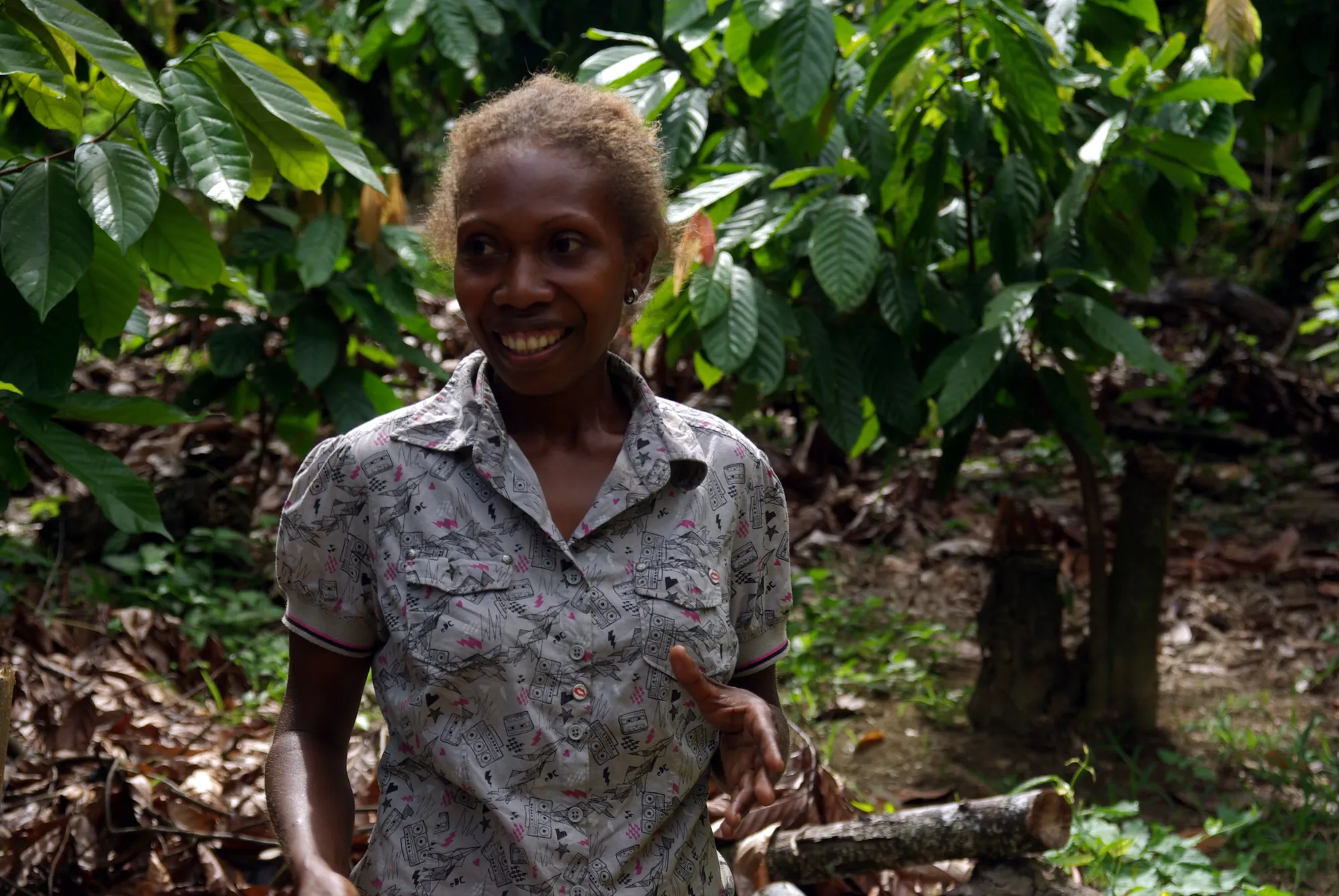 A farmer spreading cocoa beans to dry